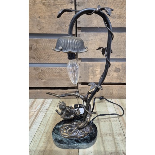 165 - Bronze table lamp sculpture, child on a swing. Raised on a marble base.