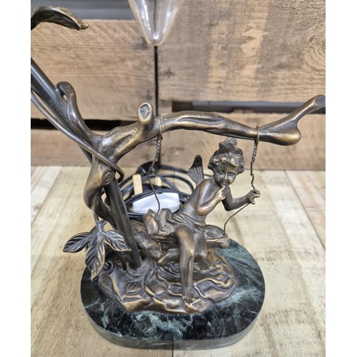 165 - Bronze table lamp sculpture, child on a swing. Raised on a marble base.