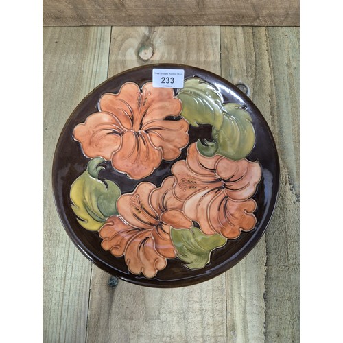 233 - Moorcroft Hibiscus pattern plate. Brown ground. Impressed marking tot he base. [26cm diameter]