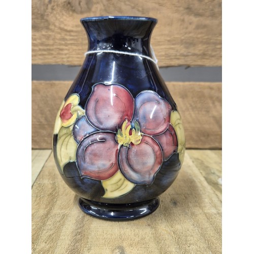 231 - Moorcroft Clematis Pattern vase. Blue ground. Impressed blue marking to the base. [13.5cm high]