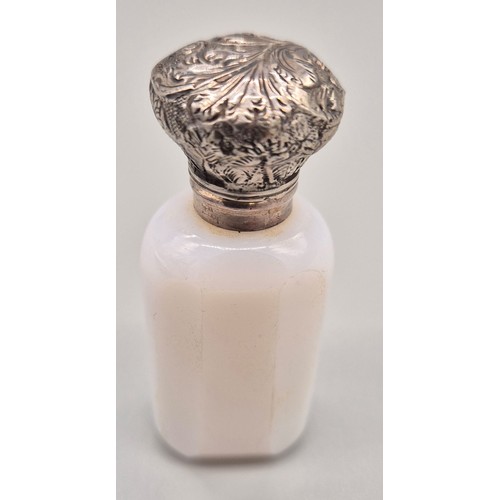 90 - Antique Milk glass perfume bottle fitted with an ornate white metal lid and has original glass stopp... 