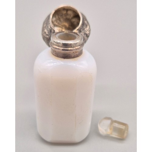 90 - Antique Milk glass perfume bottle fitted with an ornate white metal lid and has original glass stopp... 