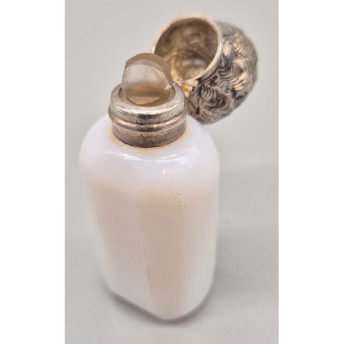 90 - Antique Milk glass perfume bottle fitted with an ornate white metal lid and has original glass stopp... 