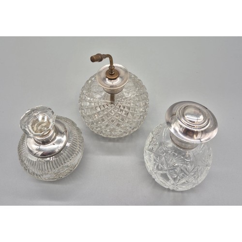 93 - Three cut crystal and silver mounted perfume bottles and atomiser.