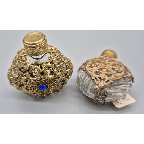 104 - Two Antique glass and metal worked perfume bottles. [6cm high]