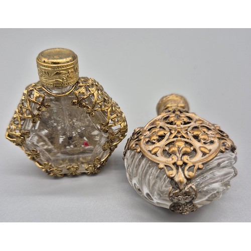 104 - Two Antique glass and metal worked perfume bottles. [6cm high]