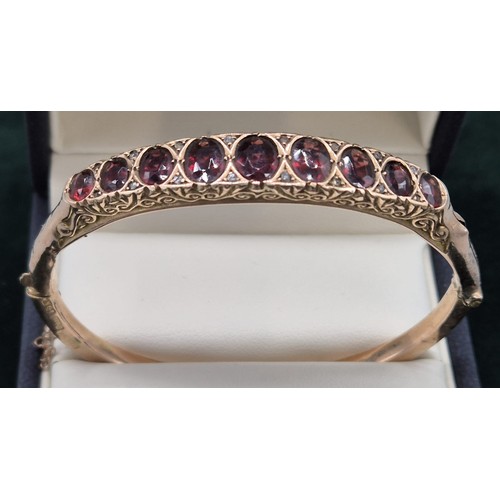 122 - Antique Chester 9ct rose gold bracelet fitted with nine various sized Garnet gem stones. [8.09grams]... 