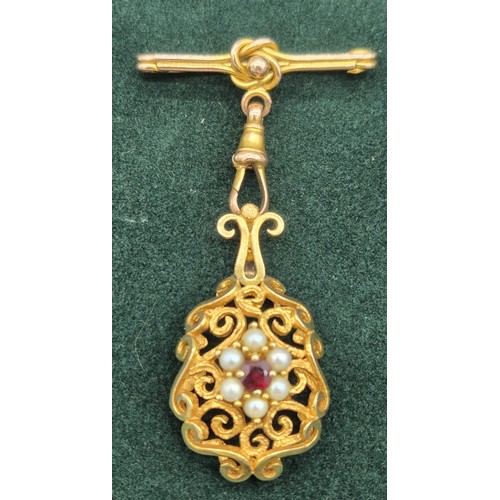 129 - Victorian 9ct yellow gold ornate hanging brooch. Set with a round cut garnet and surrounded by pearl... 