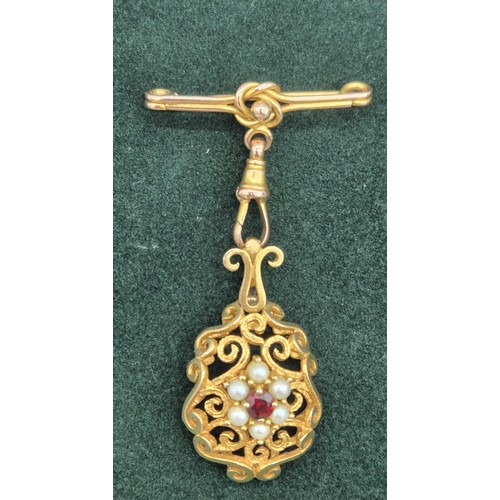 129 - Victorian 9ct yellow gold ornate hanging brooch. Set with a round cut garnet and surrounded by pearl... 