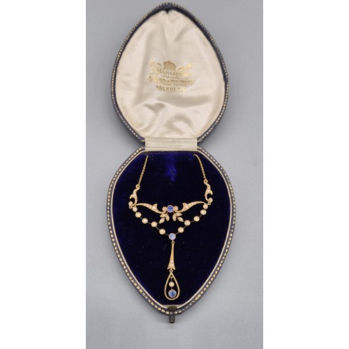 132 - Antique 15ct yellow gold ornate pendant with attached necklace. Fitted with seed pearls and three ro... 