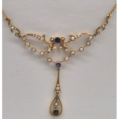 132 - Antique 15ct yellow gold ornate pendant with attached necklace. Fitted with seed pearls and three ro... 