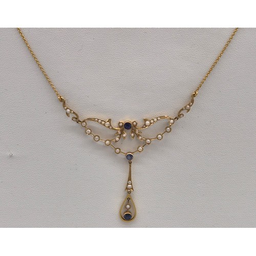 132 - Antique 15ct yellow gold ornate pendant with attached necklace. Fitted with seed pearls and three ro... 