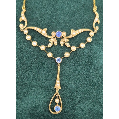 132 - Antique 15ct yellow gold ornate pendant with attached necklace. Fitted with seed pearls and three ro... 