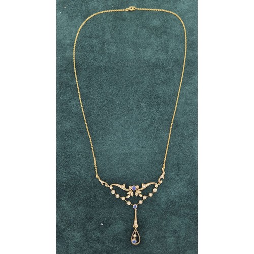 132 - Antique 15ct yellow gold ornate pendant with attached necklace. Fitted with seed pearls and three ro... 