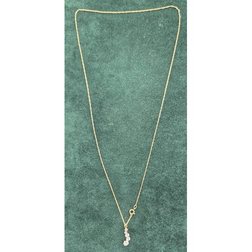 120 - 9ct yellow gold pendant with CZ Stones and a 9ct yellow gold necklace. [0.73grams]