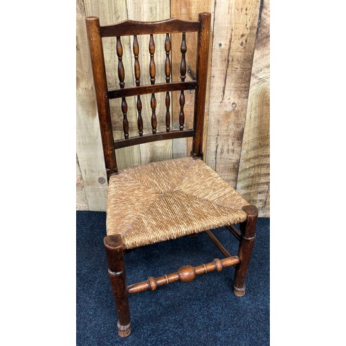 465 - 19th century country elm wood spindle back chair, with rush seat. [95cm high]