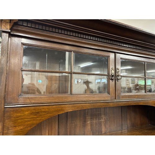 466 - Late 19th century arts and crafts inspired oak dresser. Two door section and shelved area top, Recta... 