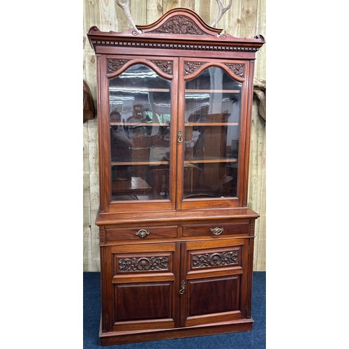 468 - Late 19th century Mahogany two section bookcase. Carved finial top leading down to carved panel and ... 