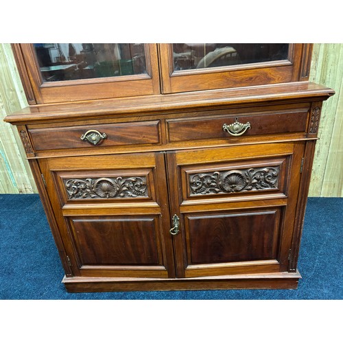 468 - Late 19th century Mahogany two section bookcase. Carved finial top leading down to carved panel and ... 