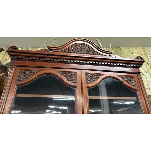 468 - Late 19th century Mahogany two section bookcase. Carved finial top leading down to carved panel and ... 