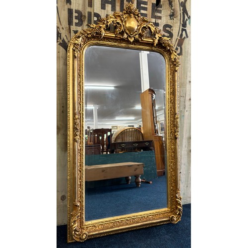 478 - Large and ornate antique regency manner hall mirror. Gilt and moulded frame. [160x82cm]