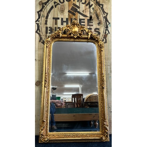 478 - Large and ornate antique regency manner hall mirror. Gilt and moulded frame. [160x82cm]