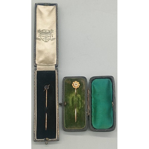 17 - Two boxed 9ct gold pins; one fitted with a single diamond. [1.86grams]