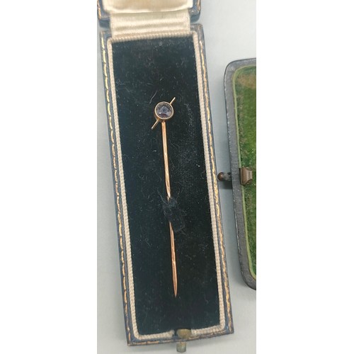 17 - Two boxed 9ct gold pins; one fitted with a single diamond. [1.86grams]