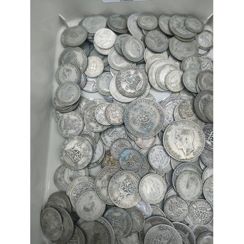 21 - A Collection of silver coinage, half crowns, three pences and six pences. [681grams]