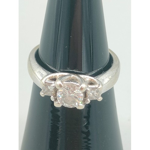 34 - A Tiffany inspired 14ct white gold and diamond set ring. Centre round cut diamond [0.50ct] off set w... 