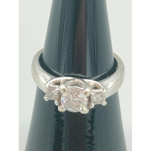 34 - A Tiffany inspired 14ct white gold and diamond set ring. Centre round cut diamond [0.50ct] off set w... 