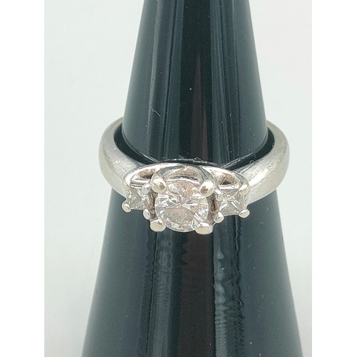 34 - A Tiffany inspired 14ct white gold and diamond set ring. Centre round cut diamond [0.50ct] off set w... 