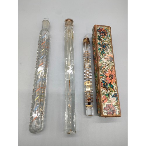 40 - Three 19th century Tear Catchers/ perfume bottles. [18.5cm in length] Two with stoppers and two with... 