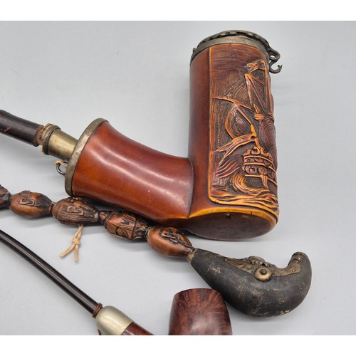 159 - A collection of six antique pipes; Black forest carved stag smoking pipe, devil style head smoking p... 