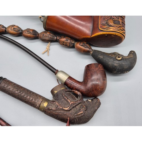 159 - A collection of six antique pipes; Black forest carved stag smoking pipe, devil style head smoking p... 