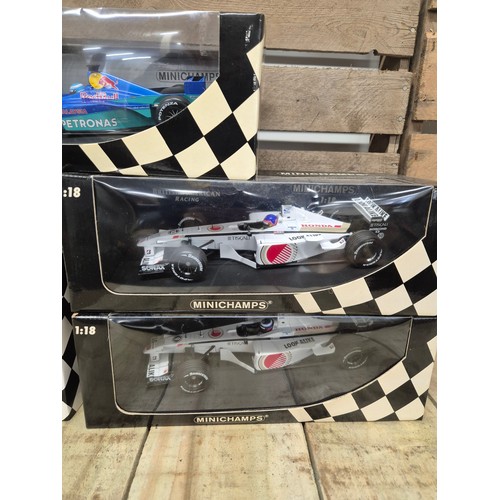 301 - A collection of five boxed mini champs 1:18 Scale formula one models; Red bull Bosworth, Tiscali, Pe... 