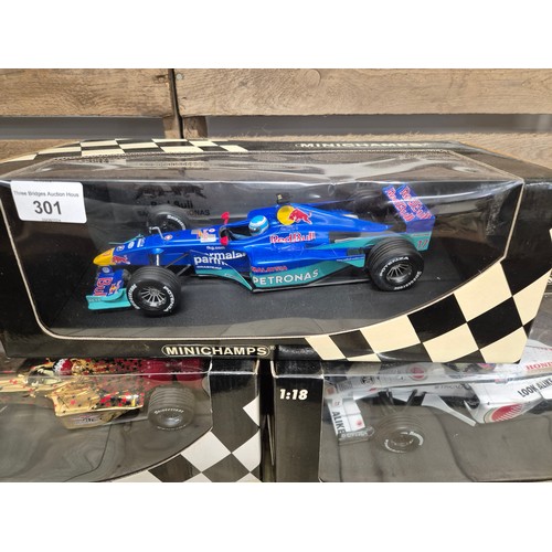 301 - A collection of five boxed mini champs 1:18 Scale formula one models; Red bull Bosworth, Tiscali, Pe... 