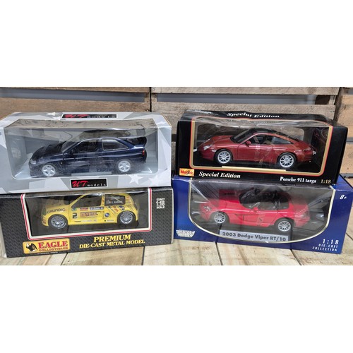 312 - A collection of four various 1.18 scale models; Ford Escorts Bosworth, Renault sport clip, 2003 dodg... 