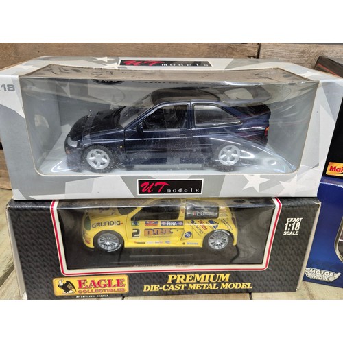 312 - A collection of four various 1.18 scale models; Ford Escorts Bosworth, Renault sport clip, 2003 dodg... 