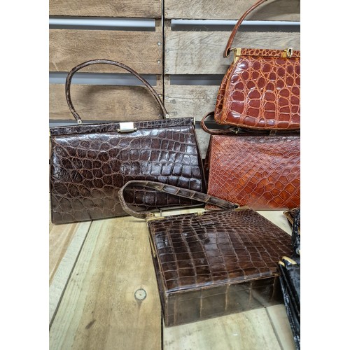 196 - A collection of eight crocodile skin vintage clutch hand bags; British & German made