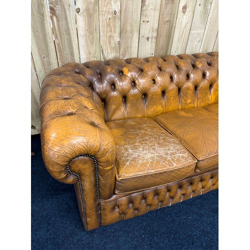 160 - Vintage Chesterfield mustard leather three seat sofa. [Cushion as found]