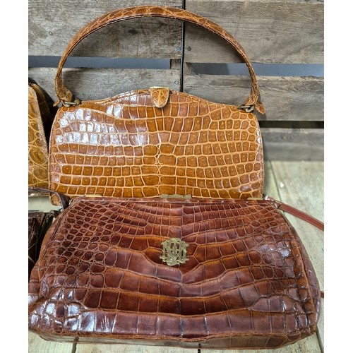 119 - Four various vintage crocodile leather hand bags; One fitted with Brass Initials and locks, Reid & T... 