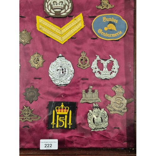 222 - A collection of Military badges & patches in a fitted display case. The Cheshire Regiment, Royal Cor... 