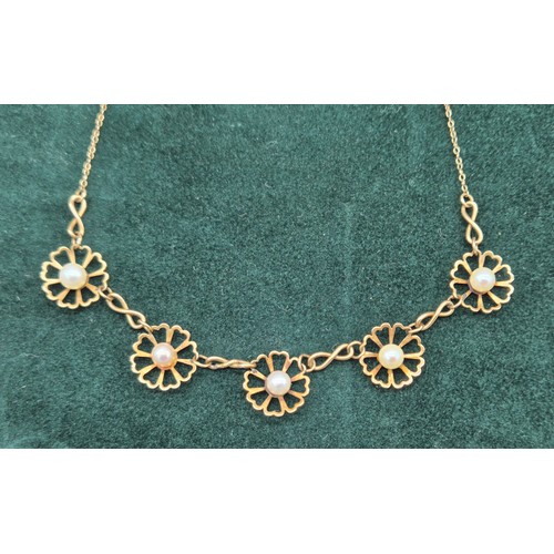 22 - 9ct yellow gold and pearl set floral design necklace. [5grams]