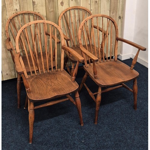 225 - A Set of four elm wood 19th century Windsor spindle back dining room arm chairs, raised on turned le... 