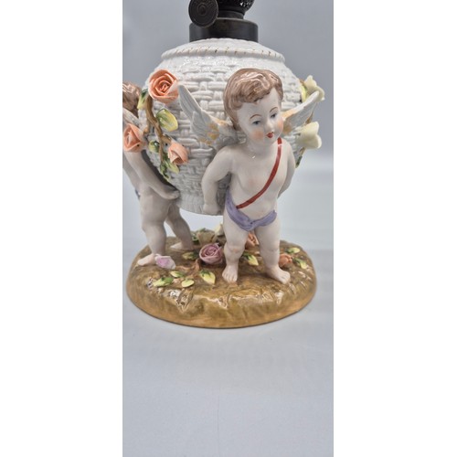 166 - 19th century German porcelain Meissen oil lamp raised on cherub figural base, comes with a glass fun... 