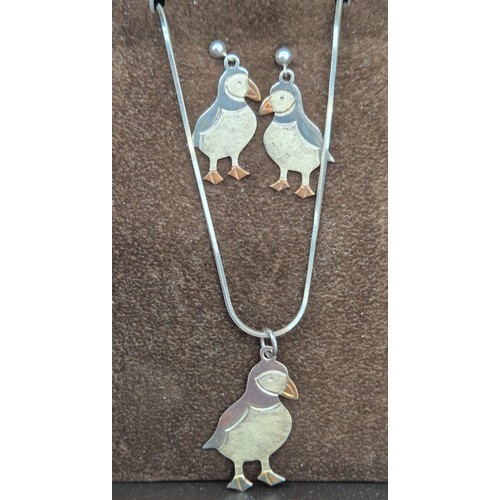 39 - 925 silver puffin pendant and matching earrings. Comes with a silver necklace.