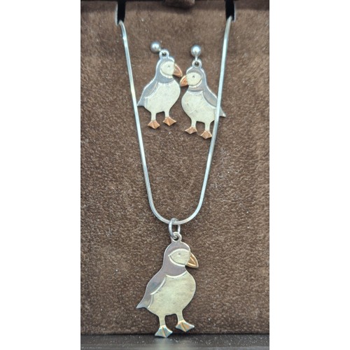 39 - 925 silver puffin pendant and matching earrings. Comes with a silver necklace.