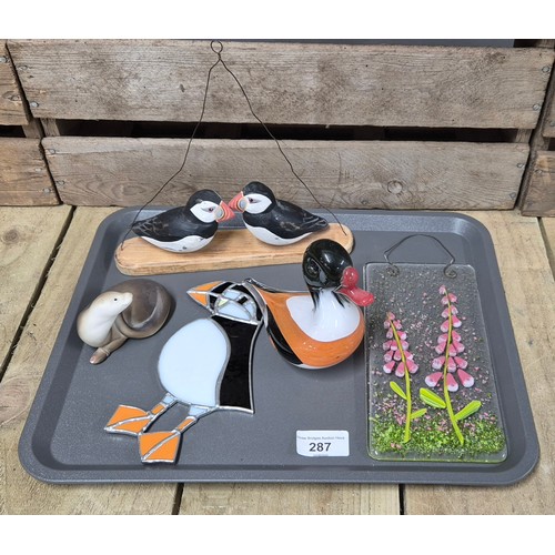 287 - A Tray of collectables; puffin figures, art glass plaque, puffin plaque & other items