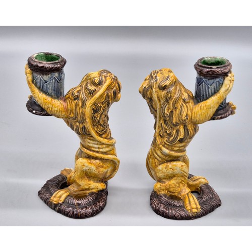 127 - A Pair of antique Majolica lion candle stick holders. [16cm high] [Old repairs to base]